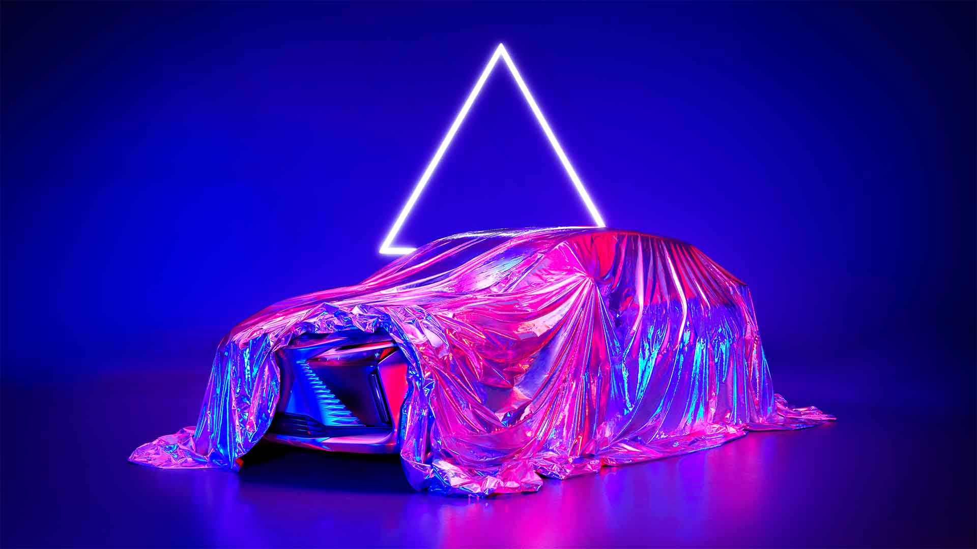 A new Lexus vehicle shrouded in a silver material cover