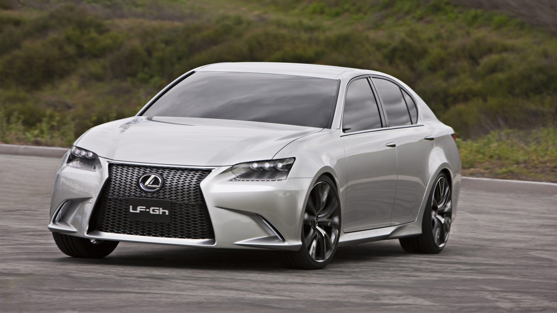 A silver LF-Gh concept car parked against a green background