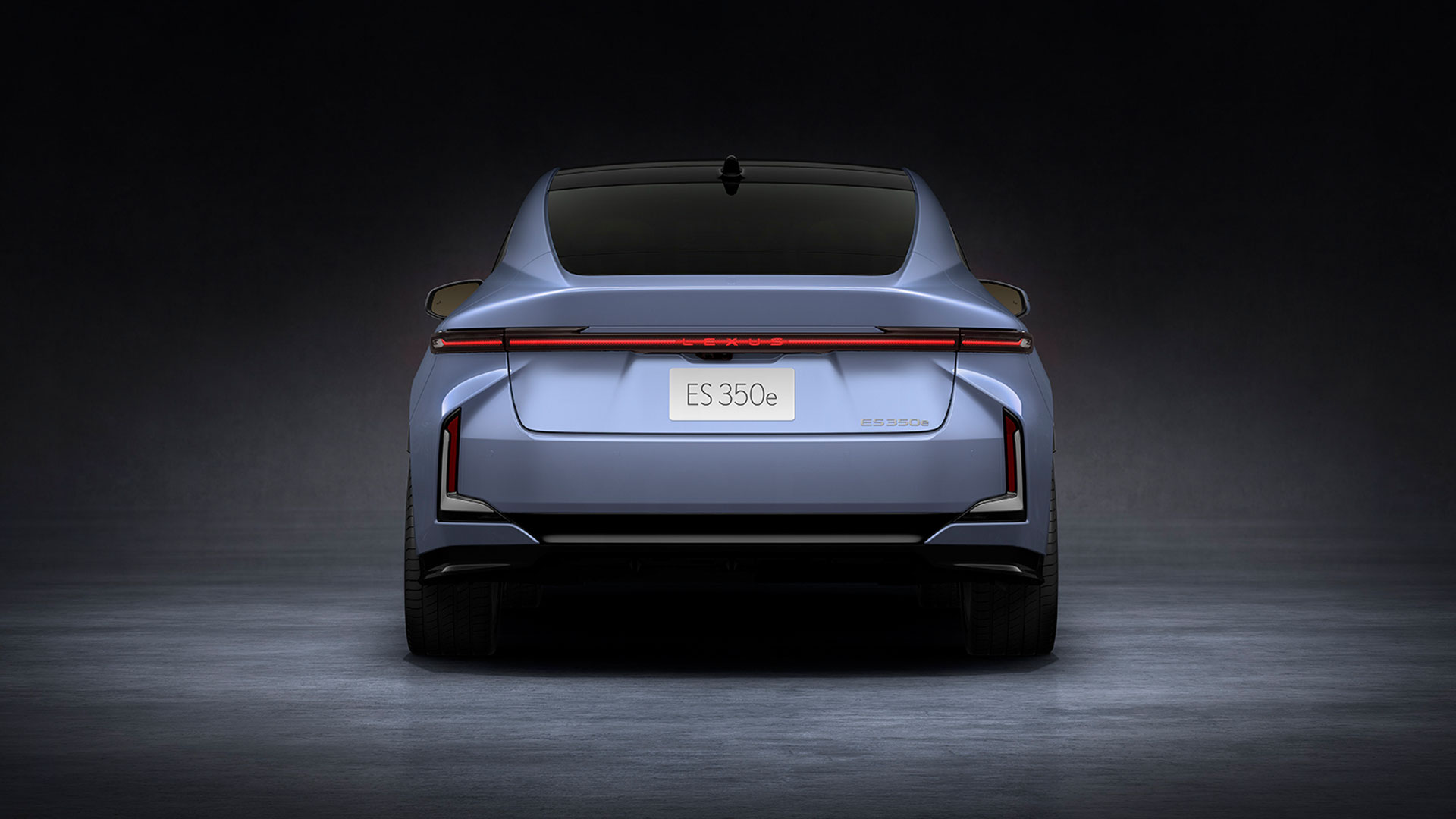 Light blue 2026 Lexus ES 350e all-electric sedan, rear view in studio setting.